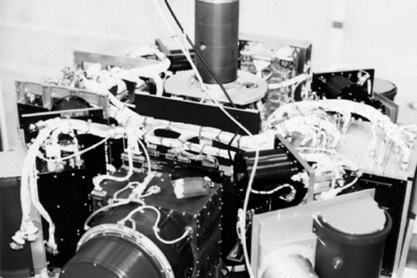 Figure 3.5: Photo shows an instrument with lots of wires and tubes on toip. Please read caption for further description.