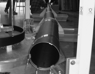 The boom is a long series of nestled cylindrical tubes. It is shown stretched out to it's full length.