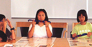 Three girls sitting down at a table