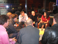 A group of people sitting around in a circle, discussion